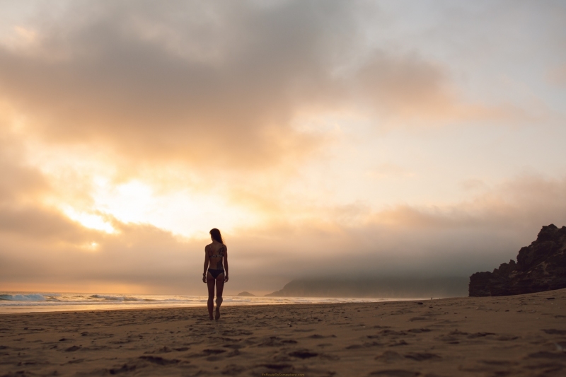 Silhouette walking towards the sunset at Myoli Beach in Sedgefield